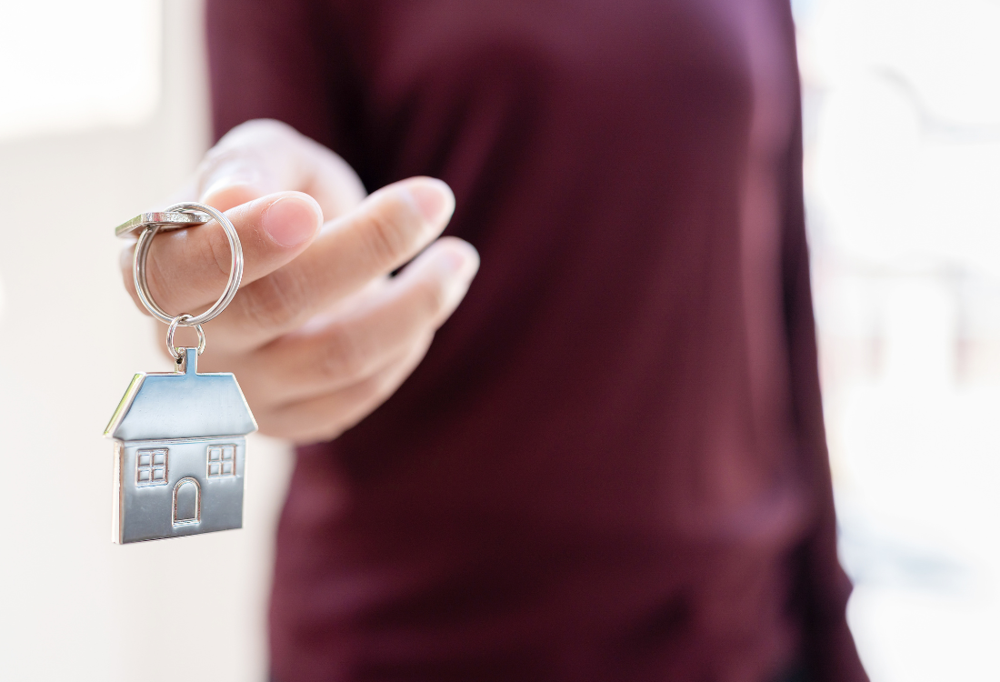 A homeowner holding their key and turning his property into a HMO with the help of a property management company